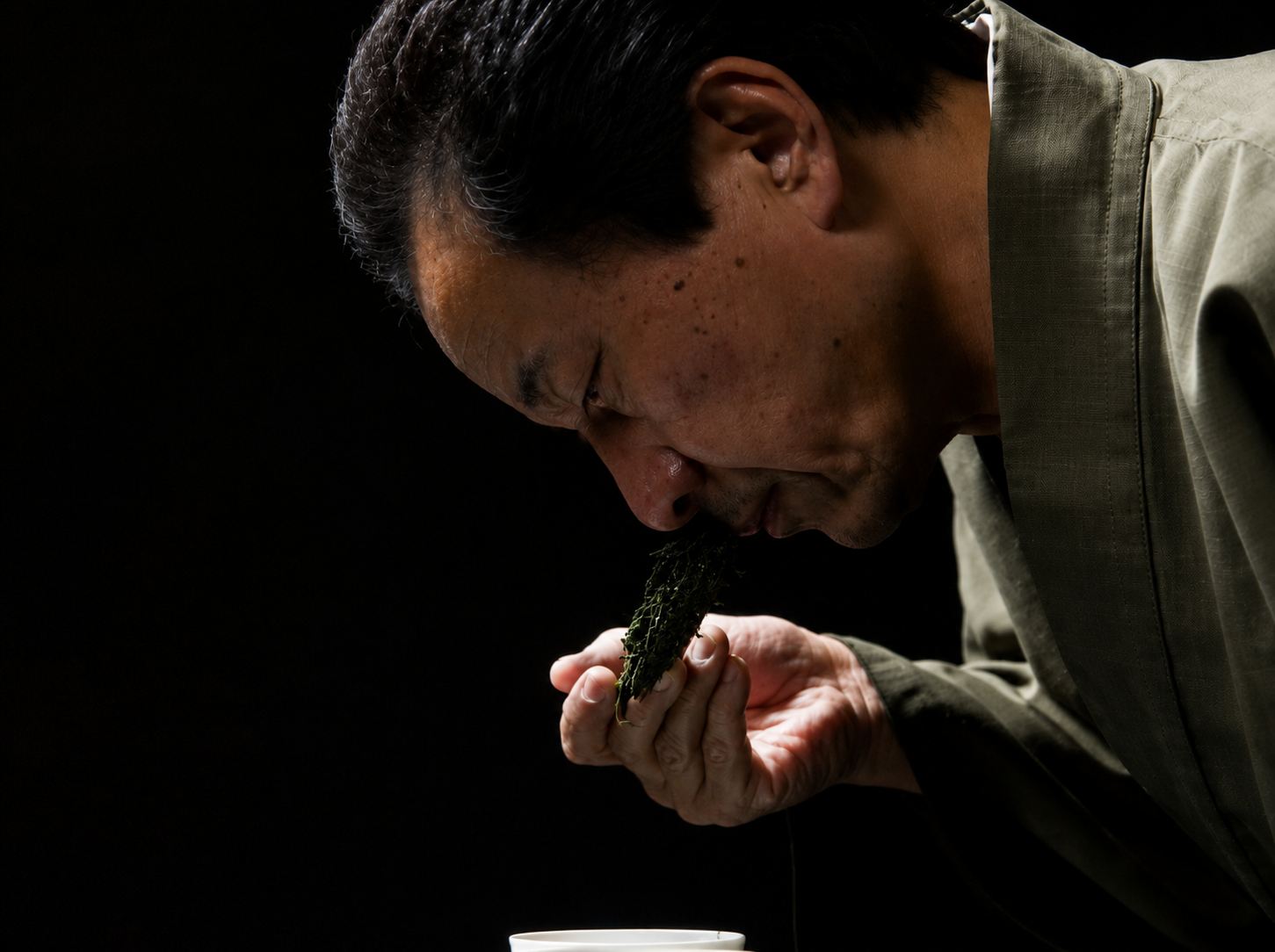 Japanese matcha specialist assessing tea